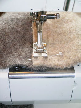 Sew the pieces together along their 12-inch sides. Overlap the edges of the fabric about 3/8 inch and use a broad, open zig-zag stitch to piece together. Clip all seams within 1/8 inch of the stitching to smooth and minimize the seams.